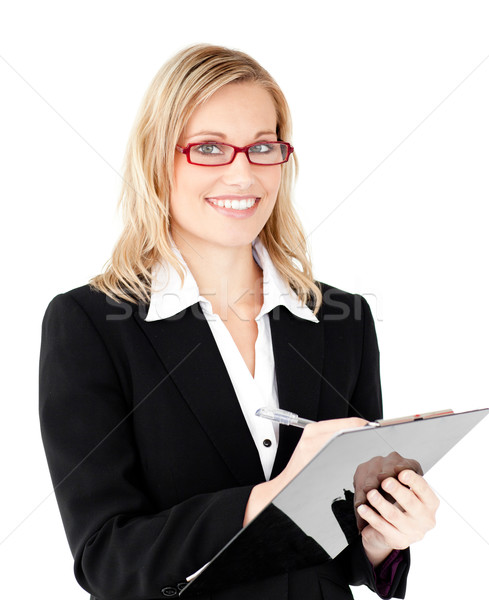 Charming businesswoman writing on a clipboard against white background Stock photo © wavebreak_media