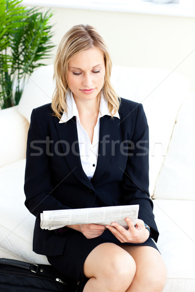 Charming businesswoman reading the newspaper on a sofa Stock photo © wavebreak_media