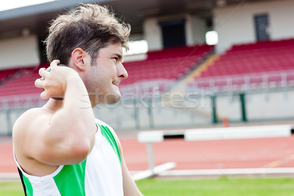 Determined male athlete preparing to throw weight in a stadium Stock photo © wavebreak_media