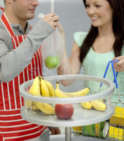 Close-up of a salesman giving an apple to his cute customer in a grocery shop Stock photo © wavebreak_media