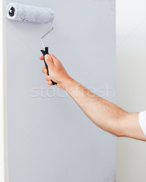 Close up of a man painting a wall in white in his new house Stock photo © wavebreak_media