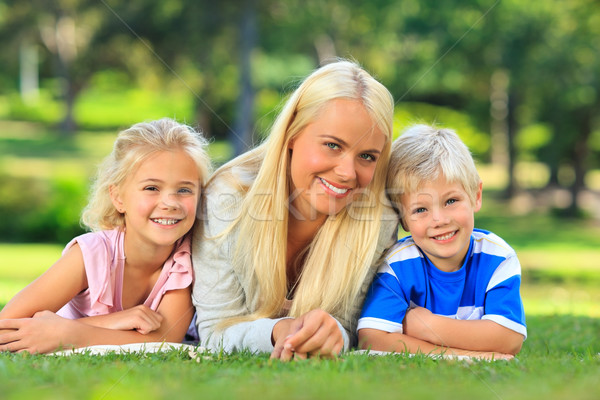 Mother with her children lying down in the park Stock photo © wavebreak_media