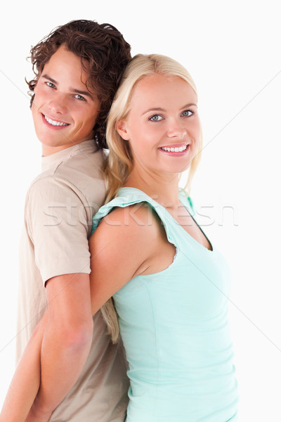 Close up of a Happy couple standing back to back in a studio Stock photo © wavebreak_media