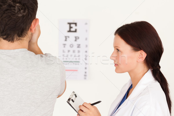 A female optician and man who uses the eye test Stock photo © wavebreak_media