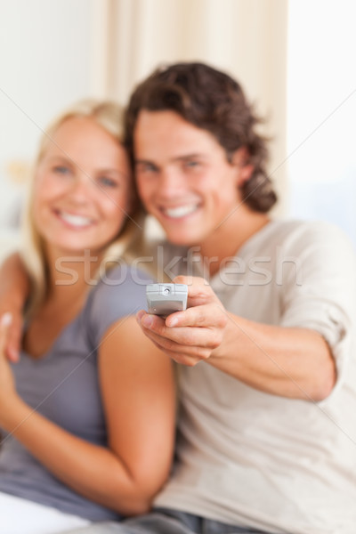 Portrait of a young couple watching TV in their living room Stock photo © wavebreak_media