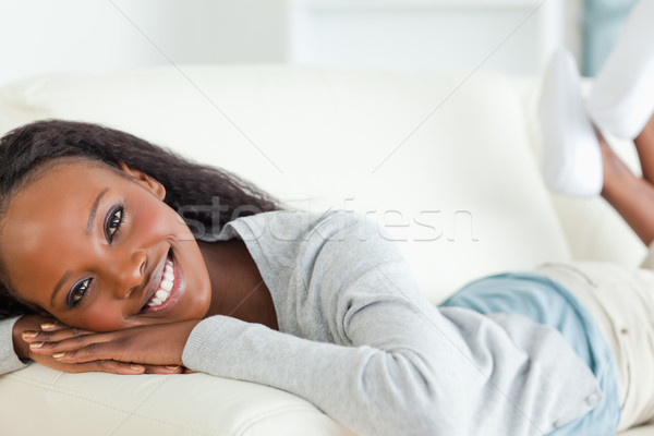 Stock photo: Close up of smiling woman taking a moment off on sofa