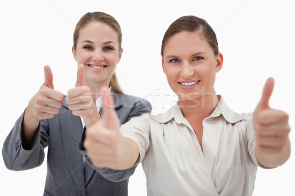 Businesswomen posing with the thumb up against a white background Stock photo © wavebreak_media