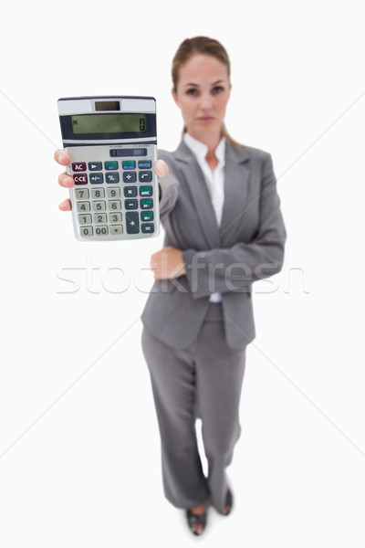 Stock photo: Bank employee showing her hand calculator against a white background