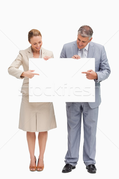 Smiling business people holding a poster against white background Stock photo © wavebreak_media