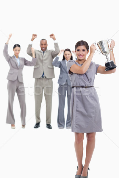 Picture centered on co-workers raising their arms in the background with a woman smiling and holding Stock photo © wavebreak_media