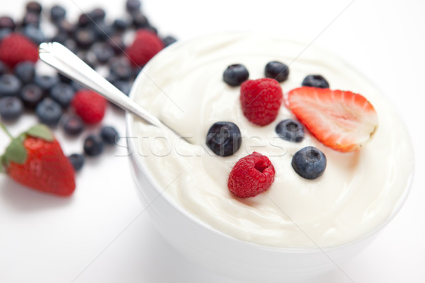 Bowl of cream with fresh berries against a white background Stock photo © wavebreak_media