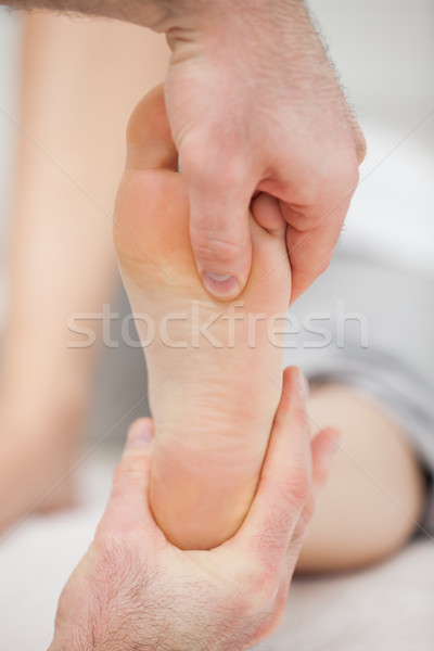 Doctor pressing his thumb on a foot in a room Stock photo © wavebreak_media