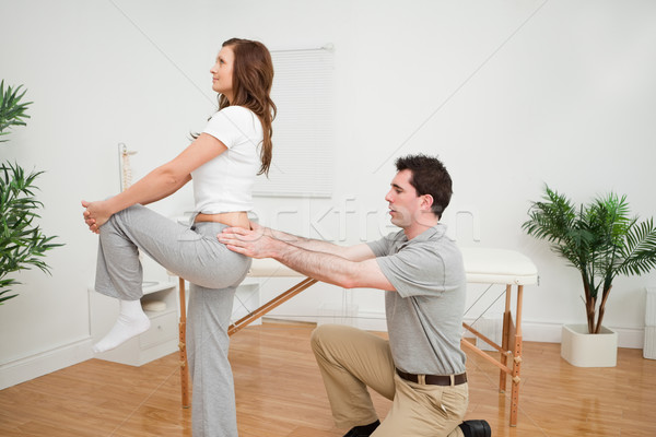 Serious woman stretching her leg in a room Stock photo © wavebreak_media