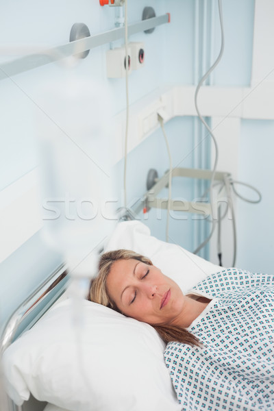 Woman lying on a medical bed while closing her eyes in hospital ward Stock photo © wavebreak_media