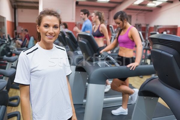 Woman wearing white t-shirt smiling in the gym Stock photo © wavebreak_media