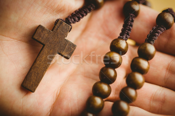 Hand holding wooden rosary beads Stock photo © wavebreak_media