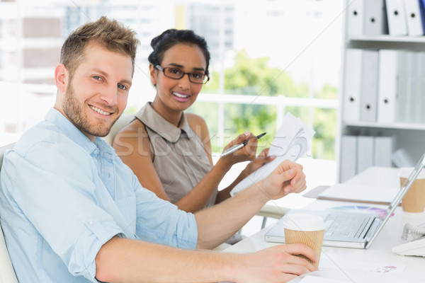Бизнес-партнеры столе улыбаясь камеры Creative Сток-фото © wavebreak_media