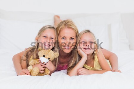 Stock photo: Siblings lying on rug looking at their yorkshire terrier with mo