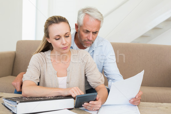 Serious couple calculating their bills at the couch Stock photo © wavebreak_media