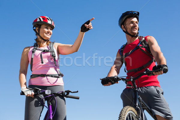 Fit cyclist couple standing at the summit Stock photo © wavebreak_media