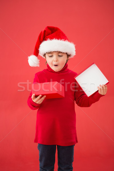 Festive little boy opening a gift Stock photo © wavebreak_media
