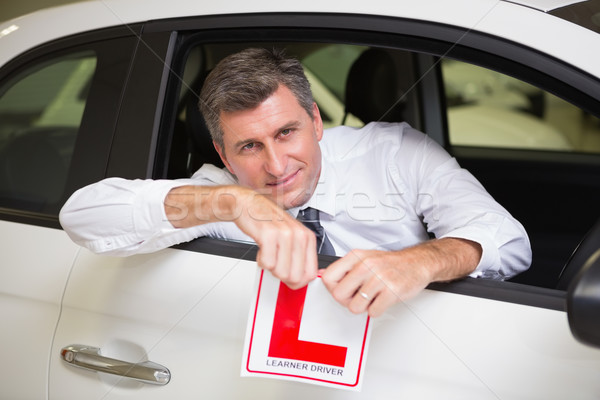 Cheerful male driver tearing up his L sign Stock photo © wavebreak_media