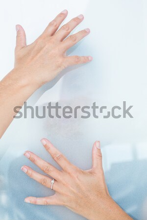 Sad blonde woman behind frosted glass Stock photo © wavebreak_media