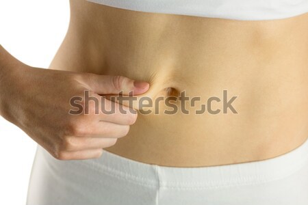 Slim woman pinching her belly Stock photo © wavebreak_media
