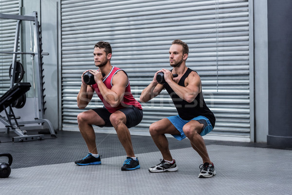 Muscular men exercising with kettlebells Stock photo © wavebreak_media