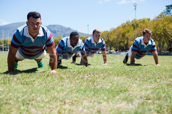 Confident rugby players doing push up at field Stock photo © wavebreak_media