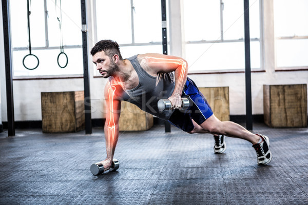 Highlighted body of strong man lifting weights at gym Stock photo © wavebreak_media