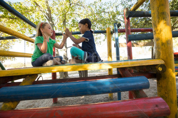 Low angle view of girls playing clapping game on jungle gym Stock photo © wavebreak_media