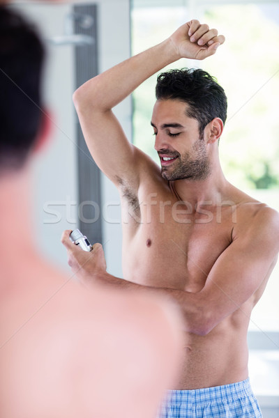 Handsome shirtless man putting deodorant Stock photo © wavebreak_media