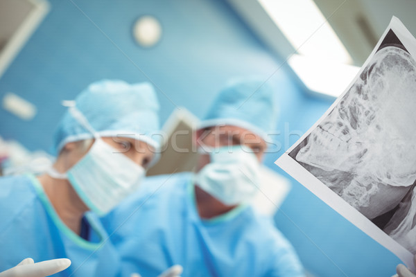 Surgeons examining x-ray in operation theater Stock photo © wavebreak_media