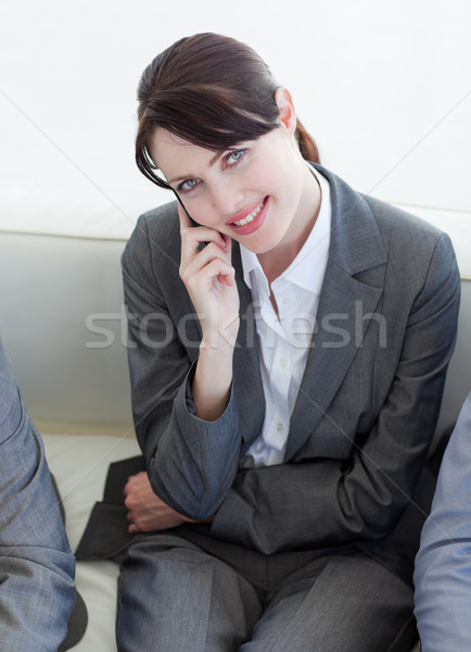 Stock photo: Businesswoman on phone sitting in a waiting room