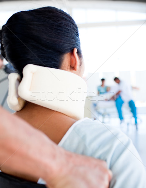 Stock photo: Close-up of a woman with a neckbrace sitting on wheelchair