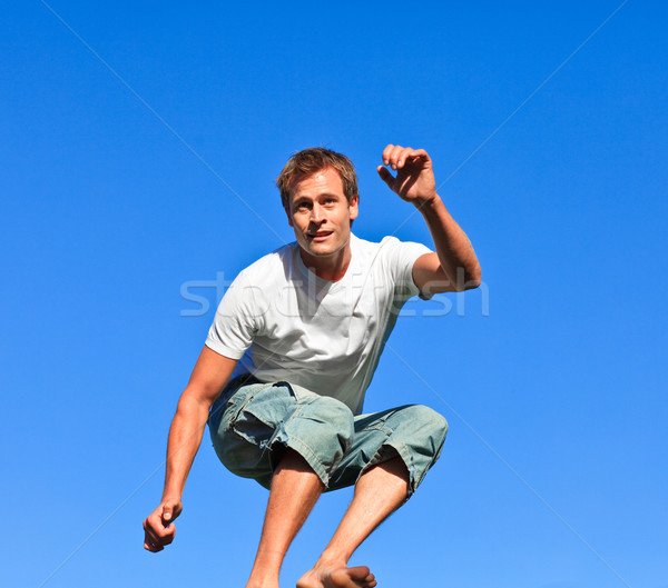 Sorridere uomo jumping blu sport estate Foto d'archivio © wavebreak_media