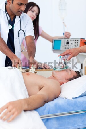 Nurse putting oxygen mask on a patient Stock photo © wavebreak_media