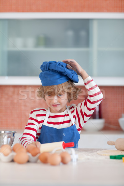 Positive little boy with a blue cap in the kitchen Stock photo © wavebreak_media