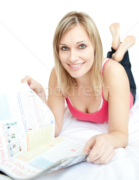Delighted woman lying on sofa and reading a book Stock photo © wavebreak_media