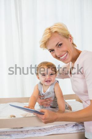 Blond mother having fun with her daughter in front of the laptop in living room Stock photo © wavebreak_media