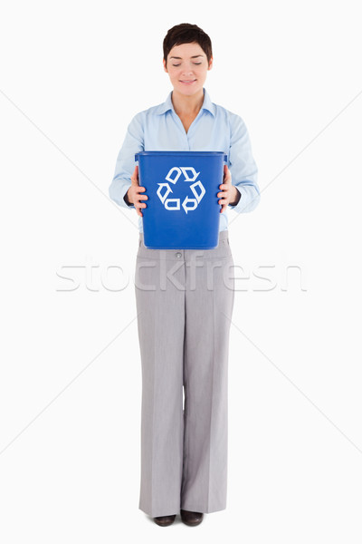 Businesswoman holding a recycling bin against a white background Stock photo © wavebreak_media