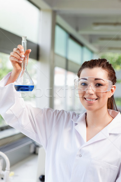 Portrait of a female science student holding a blue liquid in a laboratory Stock photo © wavebreak_media