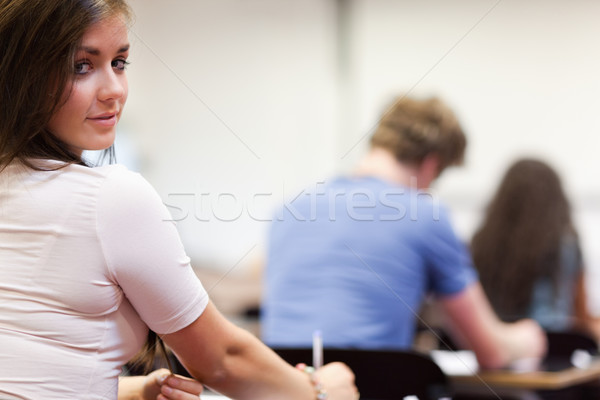 Playful student sitting at a table in a classroom Stock photo © wavebreak_media