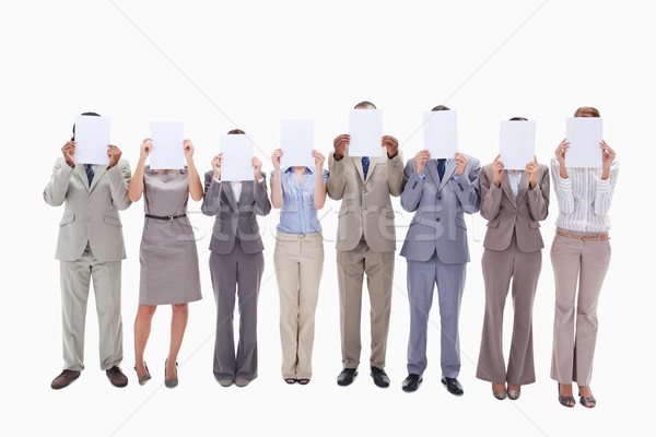 Business people hiding their faces with white support for letters against white background Stock photo © wavebreak_media