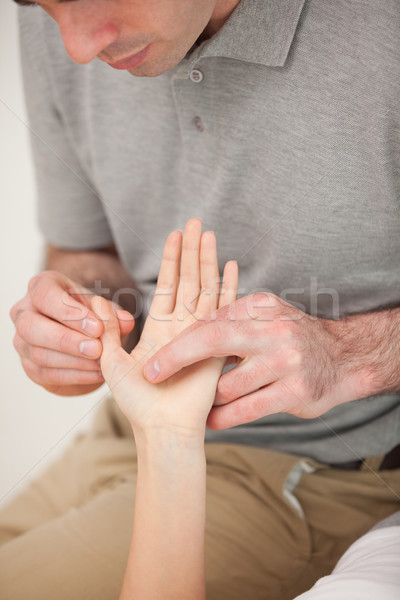 Man massaging the thumb of a woman in a room Stock photo © wavebreak_media