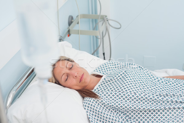 Female patient lying on a bed with closed eyes in hospital ward Stock photo © wavebreak_media