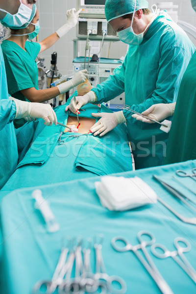 Focus on surgical team next to surgical tools in an operating theatre Stock photo © wavebreak_media