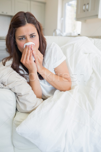 Stock photo: Woman feeling sick and lying on the sofa