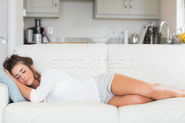 Stock photo: Woman sleeping on a couch in a kitchen